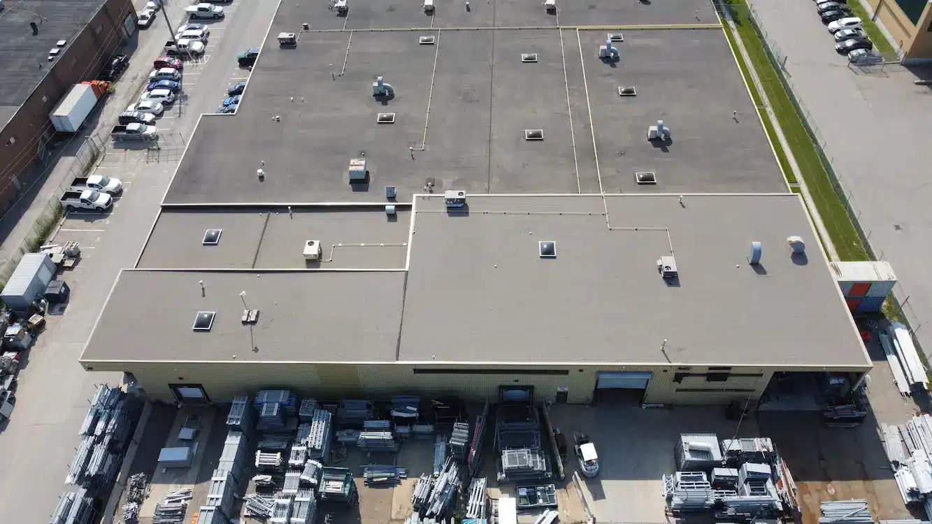 Aerial view of a completed commercial re-roofing project with 5-ply BUR system and new skylights in Brampton, Ontario