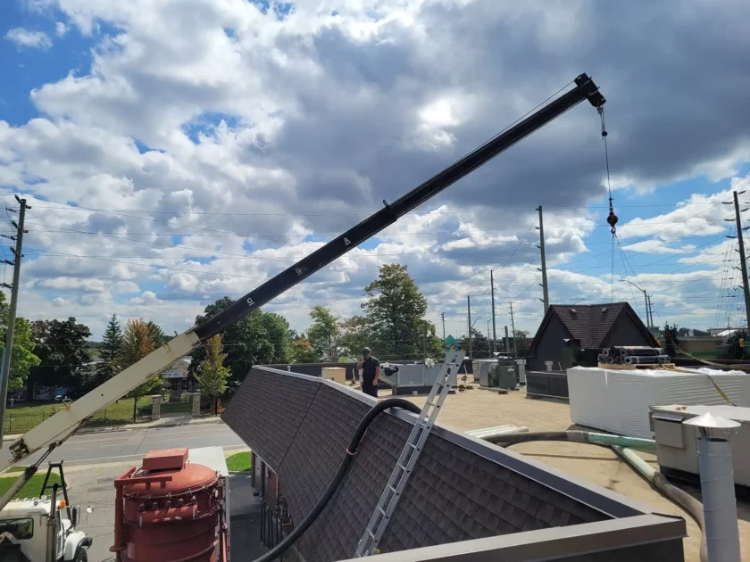 Skilled hands securing new roofing materials in place.