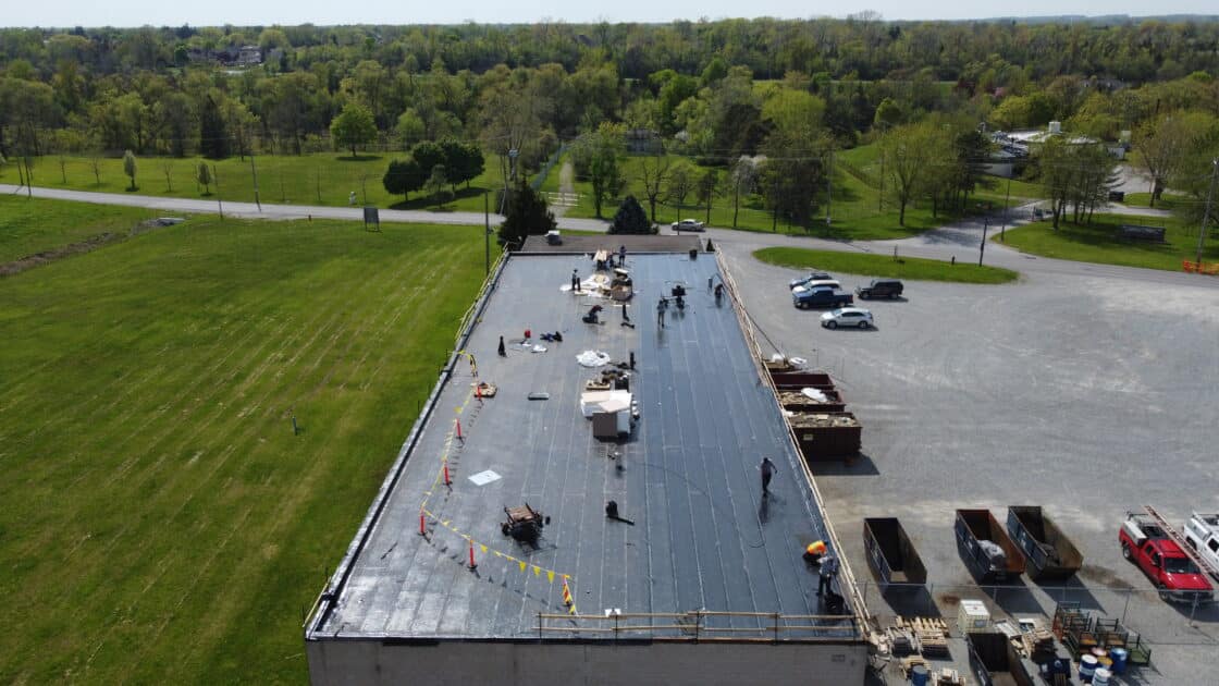 Crew applying base sheet membrane on commercial flat roof in Welland