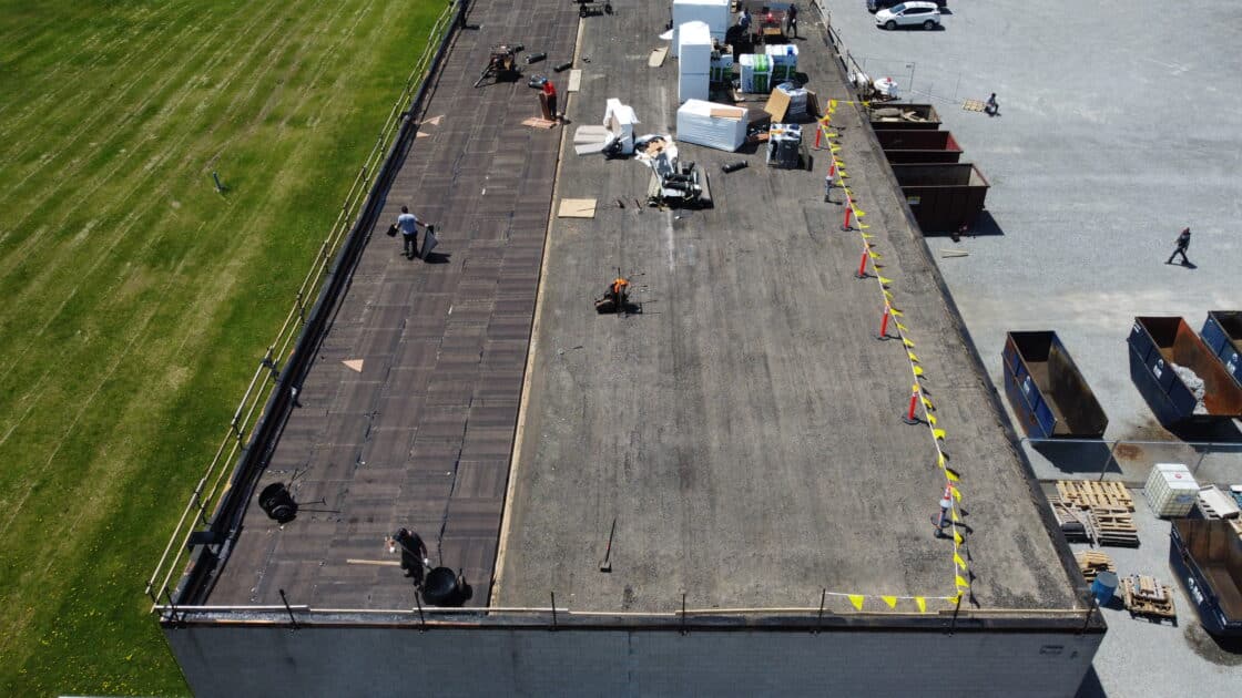 Videl Roofing contractors installing 0.5” fiberboard during Welland commercial flat roof replacement