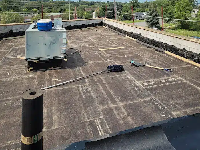 Aging 4-ply BUR flat roof showing signs of failure on a commercial building in Barrie, Ontario