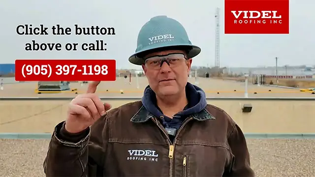 Kirby Hewines from Videl Roofing standing on a commercial flat roof explaining the free roof condition report