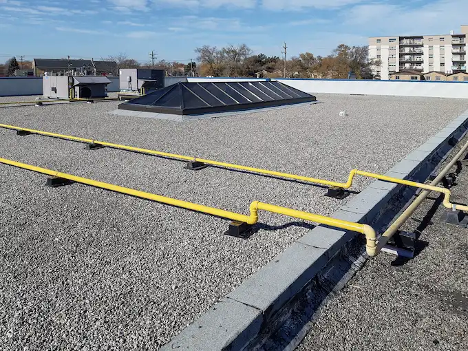 Finished BUR flat roof replacement with new drainage system on a commercial building in St. Catharines by Videl Roofing