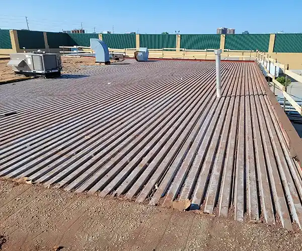 Damaged commercial flat roof with blistering and membrane splits before re-roofing in Brampton, Ontario