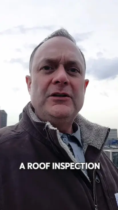 Kirby Hewines inspecting a commercial flat roof in Mississauga showing scattered patch repairs and water-soaked insulation from years without preventative maintenance