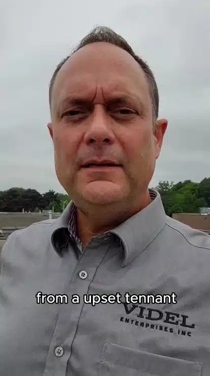 Kirby Hewines documenting open pitch pockets and unsealed doghouse penetrations during a commercial flat roof inspection